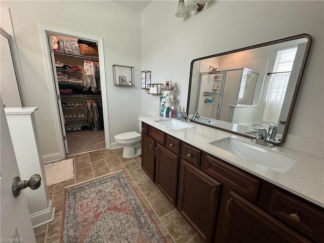 107 Saddlebrook Dr, Advance, NC 27006 - bathroom with a shower stall, a spacious closet, and double vanity