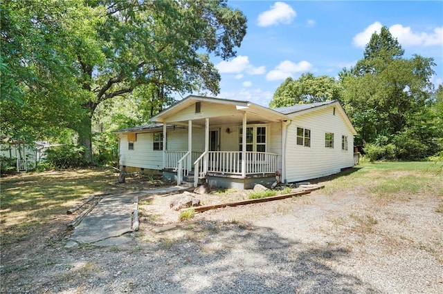 ranch-style home featuring driveway, a porch, and crawl space