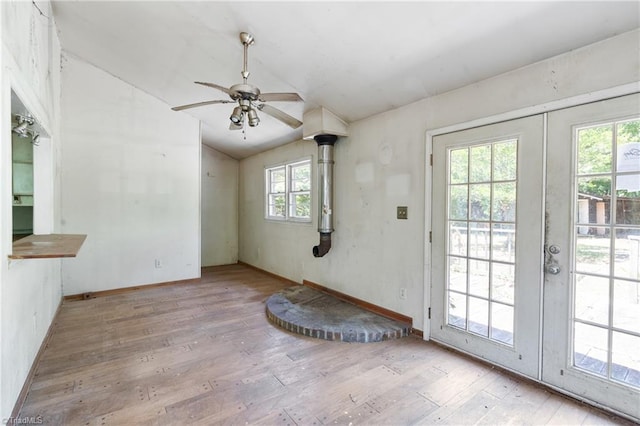 entryway featuring light wood-style floors, lofted ceiling, french doors, and a ceiling fan