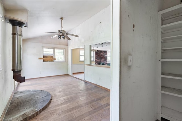 unfurnished living room featuring light wood-type flooring, ceiling fan, and vaulted ceiling