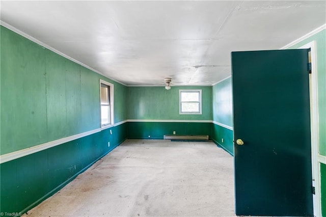 unfurnished room with ceiling fan, ornamental molding, concrete floors, and a baseboard radiator