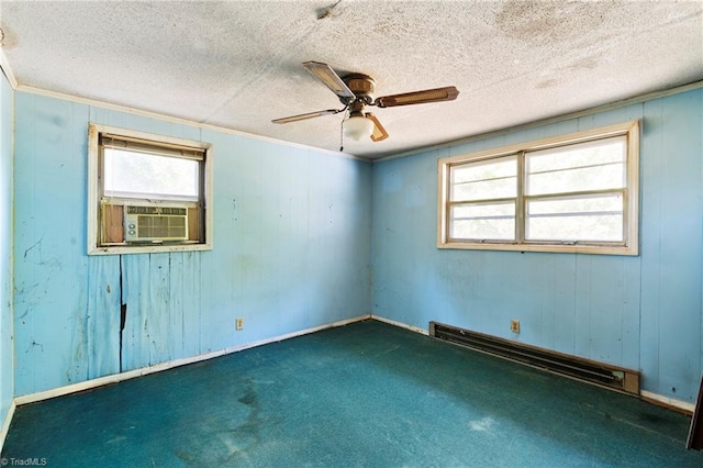 unfurnished room with a baseboard heating unit, cooling unit, a textured ceiling, and dark colored carpet