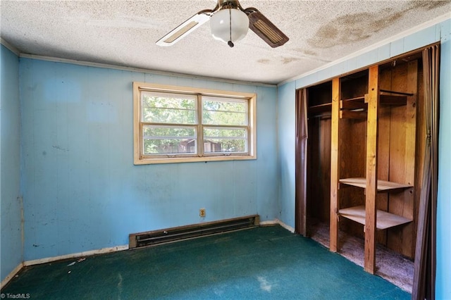 unfurnished bedroom with a ceiling fan, a baseboard radiator, ornamental molding, a textured ceiling, and dark carpet