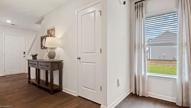 hallway with dark hardwood / wood-style flooring