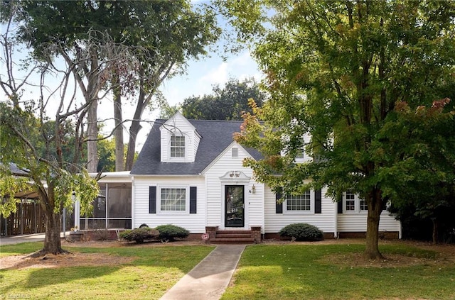 cape cod home with a sunroom and a front yard