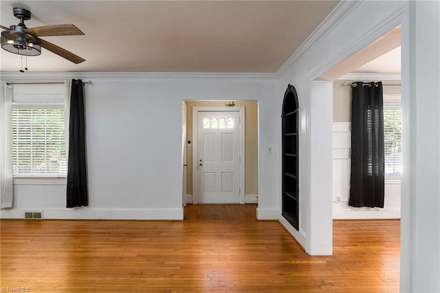 foyer entrance featuring light wood-type flooring, ceiling fan, and a healthy amount of sunlight