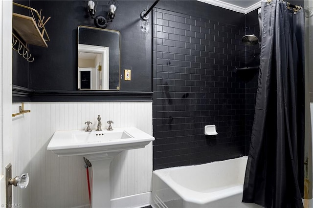 bathroom with crown molding and shower / bath combo with shower curtain