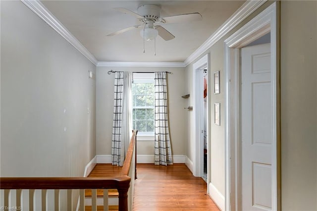 foyer entrance with light wood-type flooring, ceiling fan, and crown molding