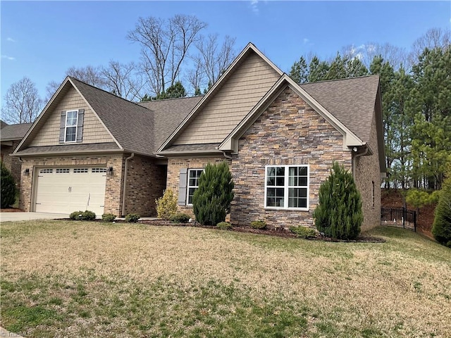 craftsman house featuring driveway, stone siding, roof with shingles, a front yard, and a garage