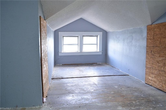 2706 W English Rd, High Point, NC 27262 - additional living space with lofted ceiling, a textured ceiling, and a textured wall