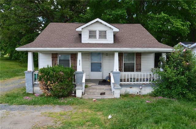 2706 W English Rd, High Point, NC 27262 - bungalow-style house featuring a porch, a shingled roof, and a front lawn