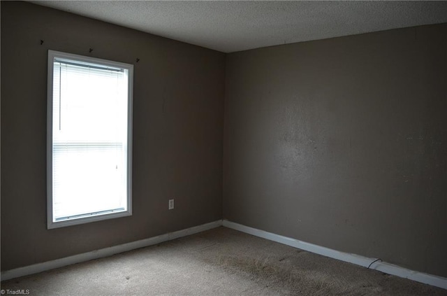 2706 W English Rd, High Point, NC 27262 - spare room featuring carpet, baseboards, and a textured ceiling