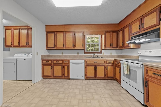 3785 Ellisboro Rd, Stokesdale, NC 27357 - kitchen featuring white appliances, under cabinet range hood, independent washer and dryer, a sink, and brown cabinetry