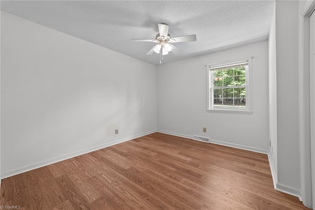 3785 Ellisboro Rd, Stokesdale, NC 27357 - empty room featuring wood finished floors, ceiling fan, baseboards, and a textured ceiling