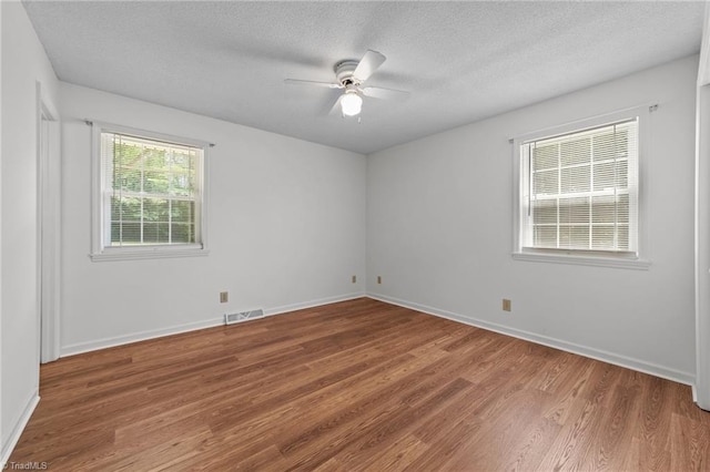 3785 Ellisboro Rd, Stokesdale, NC 27357 - unfurnished room featuring wood finished floors, a ceiling fan, a textured ceiling, and baseboards