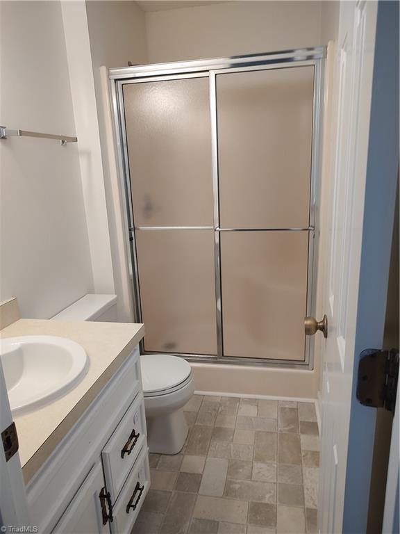 3785 Ellisboro Rd, Stokesdale, NC 27357 - full bathroom featuring an enclosed shower, vanity, and toilet