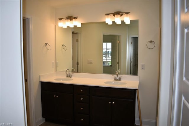 bathroom featuring a sink and double vanity