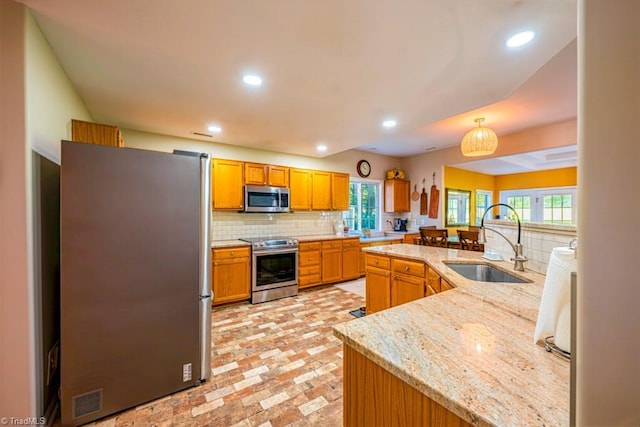 121 Walter Hagen Dr, Mebane, NC 27302 - kitchen with stainless steel appliances, a sink, brick patterned flooring, backsplash, and recessed lighting