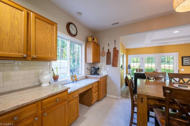 121 Walter Hagen Dr, Mebane, NC 27302 - kitchen with healthy amount of natural light, brown cabinets, and backsplash