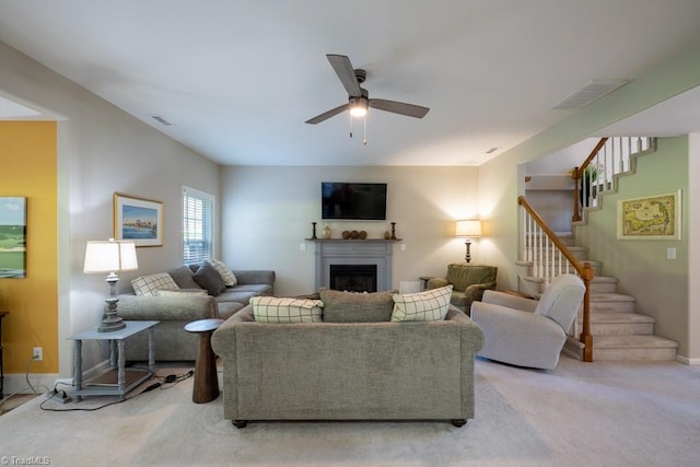 121 Walter Hagen Dr, Mebane, NC 27302 - living room with stairs, ceiling fan, a fireplace, light colored carpet, and baseboards