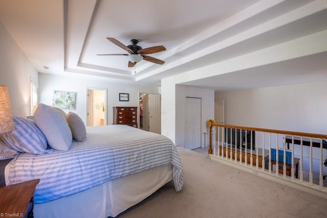 121 Walter Hagen Dr, Mebane, NC 27302 - bedroom featuring a tray ceiling, carpet floors, ceiling fan, and ensuite bath
