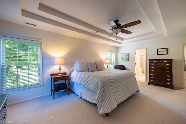 121 Walter Hagen Dr, Mebane, NC 27302 - bedroom with a tray ceiling, light carpet, baseboards, and a ceiling fan