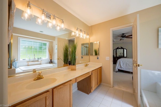 121 Walter Hagen Dr, Mebane, NC 27302 - ensuite bathroom with double vanity, a garden tub, tile patterned flooring, a ceiling fan, and baseboards