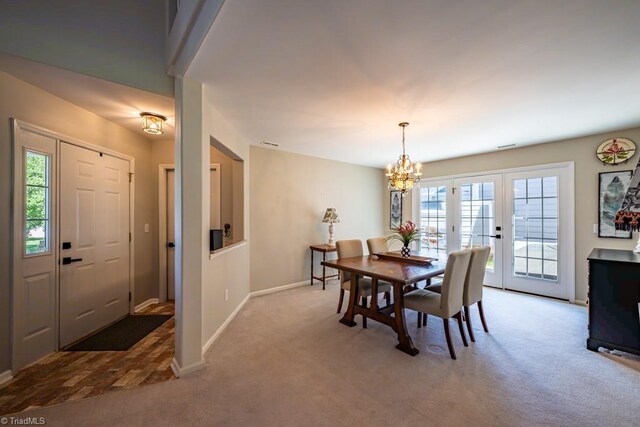 121 Walter Hagen Dr, Mebane, NC 27302 - carpeted dining space with a chandelier, baseboards, and plenty of natural light
