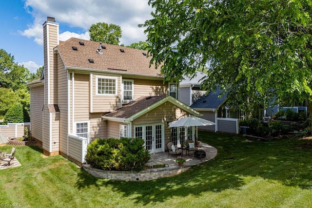 121 Walter Hagen Dr, Mebane, NC 27302 - back of property with french doors, a chimney, a patio area, and a lawn