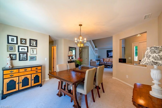 121 Walter Hagen Dr, Mebane, NC 27302 - dining room featuring a chandelier, light carpet, baseboards, and stairs