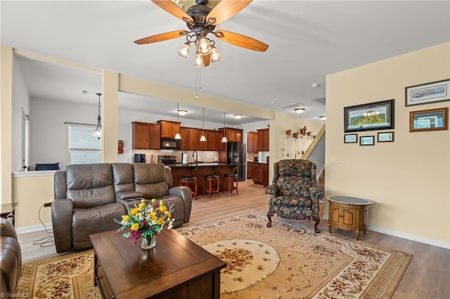 1720 Ridge Bluff Cir, Rural Hall, NC 27045 - living area with light wood-style flooring, a ceiling fan, and stairs
