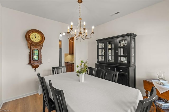 1720 Ridge Bluff Cir, Rural Hall, NC 27045 - dining room with a chandelier and wood finished floors