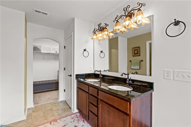 1720 Ridge Bluff Cir, Rural Hall, NC 27045 - bathroom featuring double vanity, a spacious closet, and a chandelier