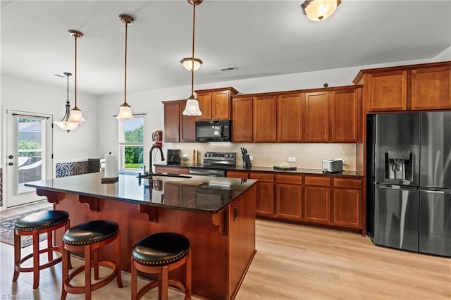 1720 Ridge Bluff Cir, Rural Hall, NC 27045 - kitchen featuring fridge with ice dispenser, black microwave, electric range, light wood finished floors, and brown cabinetry