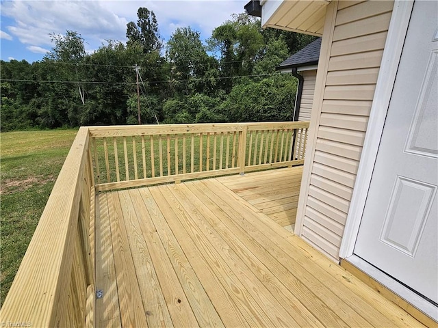 wooden deck featuring a yard