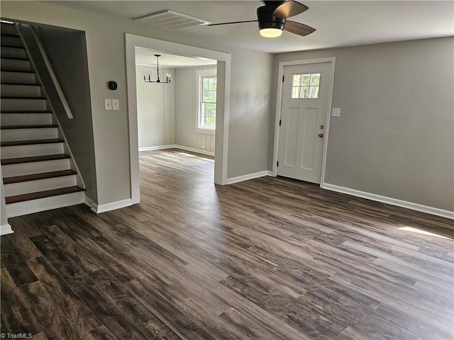 entrance foyer featuring dark wood-type flooring, visible vents, stairway, and baseboards