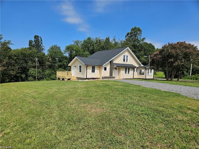 view of front of property with a deck and a front yard