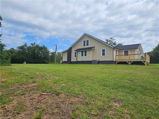 exterior space with cooling unit, a lawn, and a wooden deck