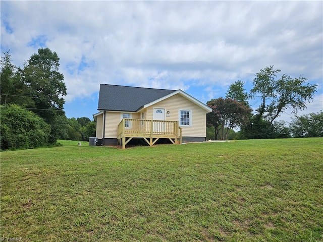 exterior space featuring a deck and a lawn