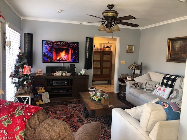 living room with crown molding and ceiling fan