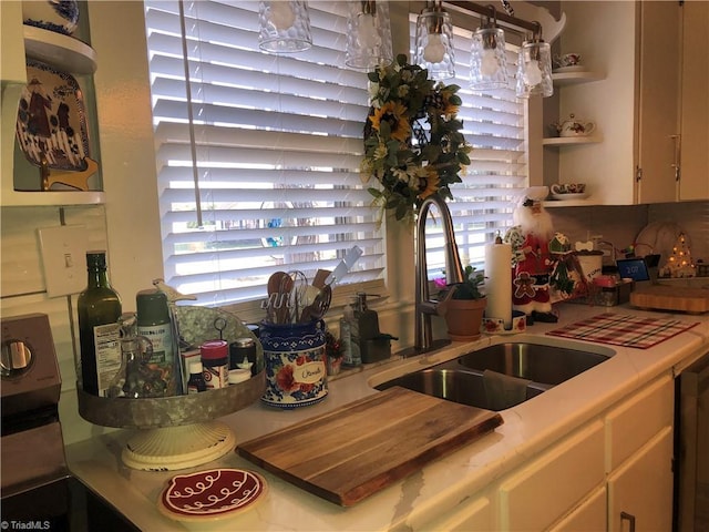 kitchen with sink, backsplash, and white cabinets