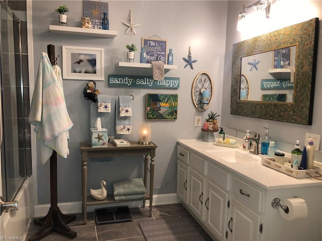 bathroom featuring combined bath / shower with glass door and vanity