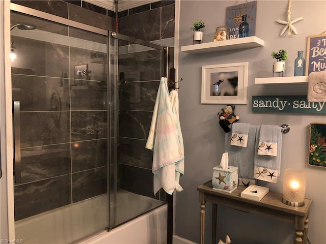 bathroom featuring combined bath / shower with glass door