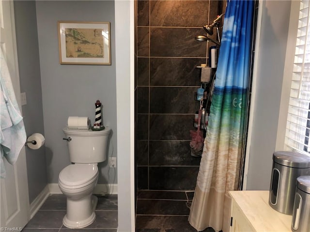 bathroom with tile patterned floors, toilet, and curtained shower