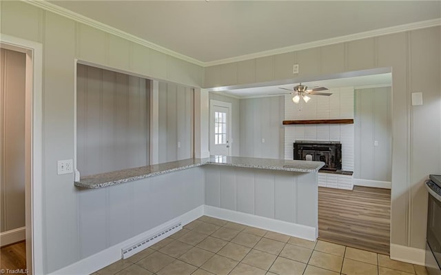 4249 High Point Rd, Winston-Salem, NC 27107 - kitchen featuring ornamental molding, a baseboard heating unit, light stone countertops, ceiling fan, and light tile patterned floors