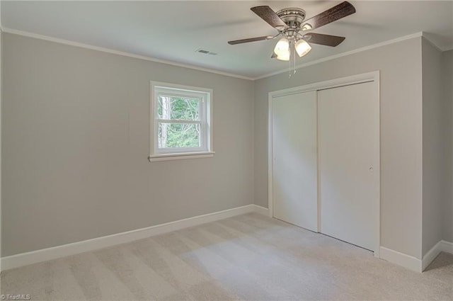 4249 High Point Rd, Winston-Salem, NC 27107 - unfurnished bedroom featuring carpet flooring, crown molding, a closet, and a ceiling fan