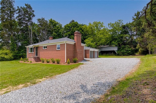 4249 High Point Rd, Winston-Salem, NC 27107 - view of home's exterior with a chimney, a lawn, brick siding, a garage, and view of scattered trees