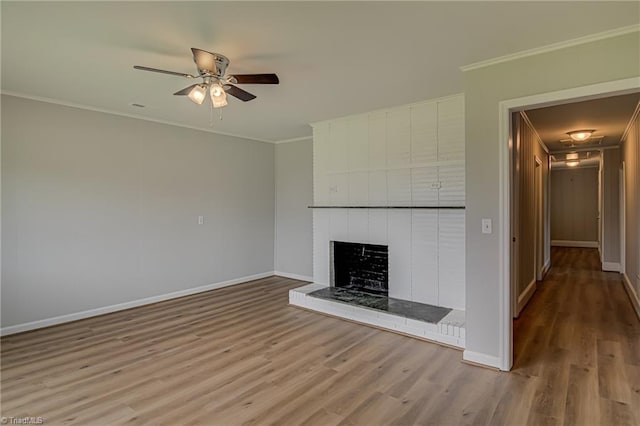 4249 High Point Rd, Winston-Salem, NC 27107 - unfurnished living room with wood finished floors, crown molding, a ceiling fan, and a fireplace