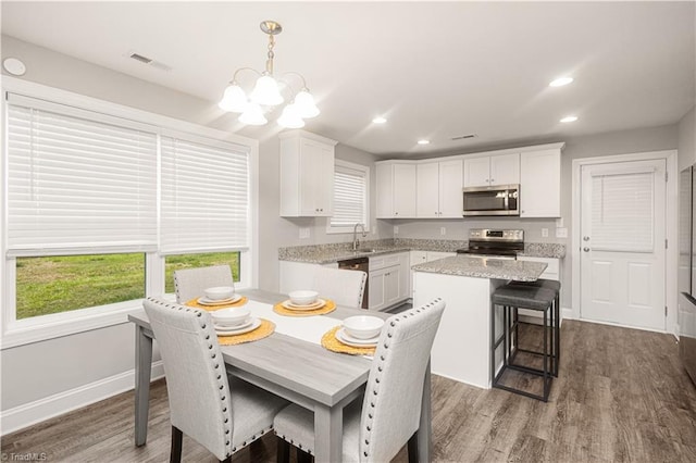 815 Martin Luther King Jr Ave, Salisbury, NC 28144 - kitchen featuring stainless steel appliances, white cabinets, recessed lighting, a kitchen island, and a chandelier