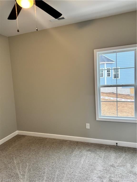 carpeted empty room featuring ceiling fan